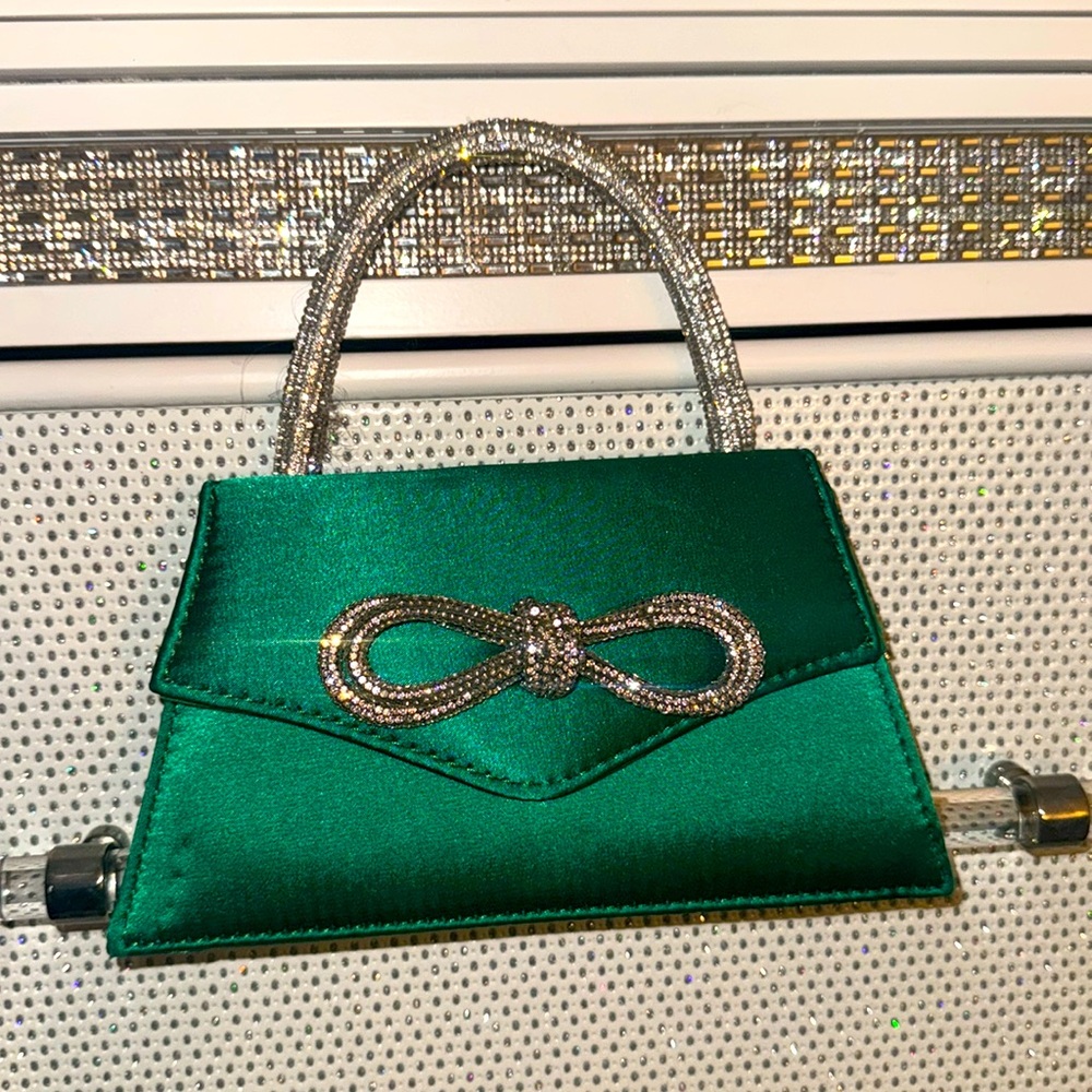 Brand new mini green purse/bag. Has a little water stain but can be removed